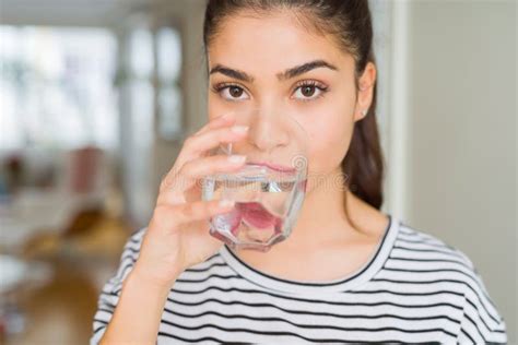Beautiful Young Woman Drinking A Fresh Glass Of Water At Home Stock
