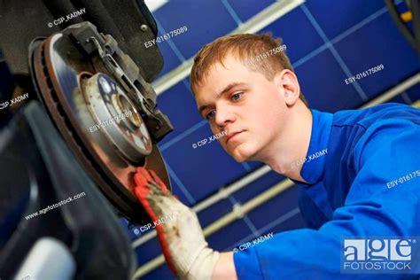 Auto Mechanic At Car Brake Shoes Eximining Stock Photo Picture And