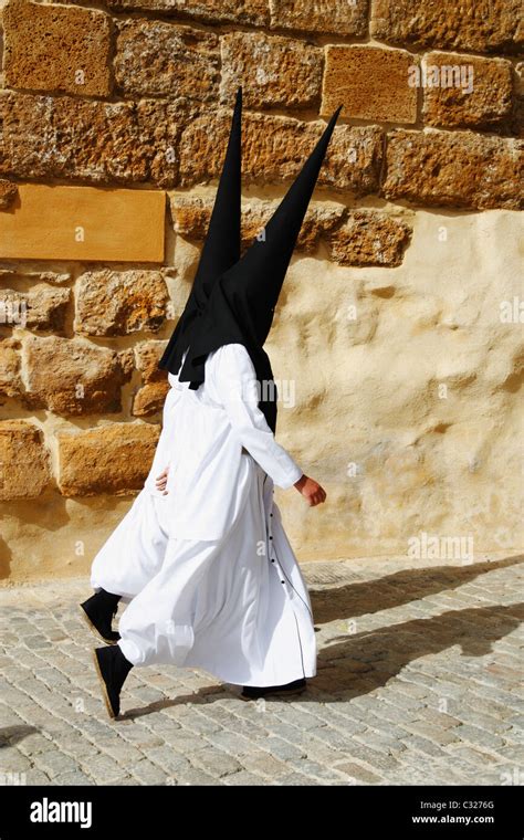 Hooded Penitents Near Church During Semana Santa Easter Holy Week In