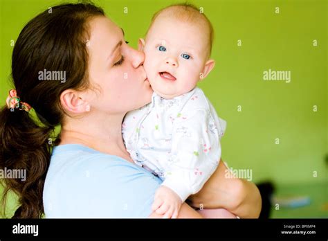 Mother Kiss Her Baby On Green Background Stock Photo Alamy