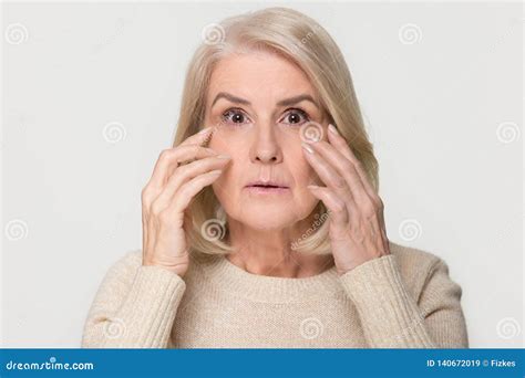 old mature woman looking at camera worried about face wrinkles stock image image of elderly