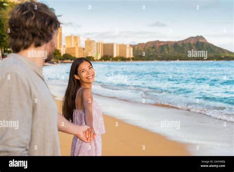 Couple Relaxing Holding Hands Having Fun On Waikiki Beach Hawaii Vacation Happy Tourists People