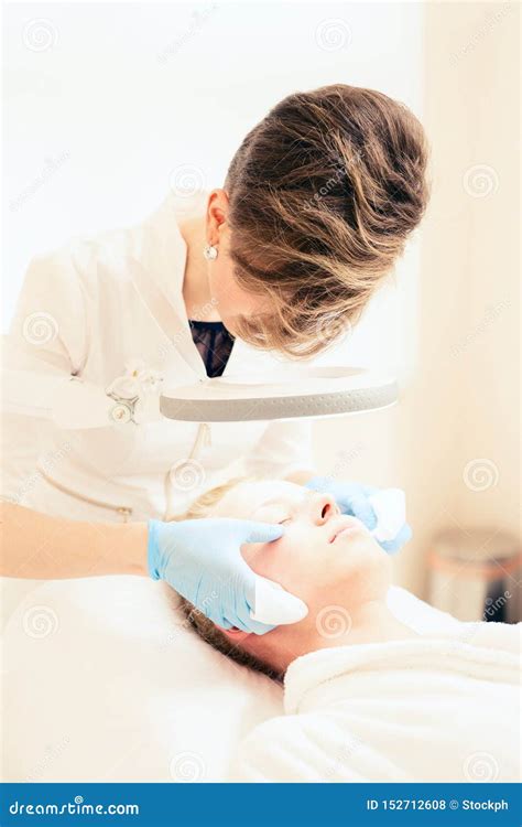 Cosmetologist`s Office Beautician Makes Facial Massage Stock Photo