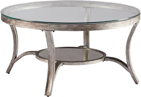 This classic cocktail table is topped with an inset mirror to add sparkle and to facilitate styling and serving. Cole Champagne Metal Cocktail Table from Standard Furniture | Coleman Furniture