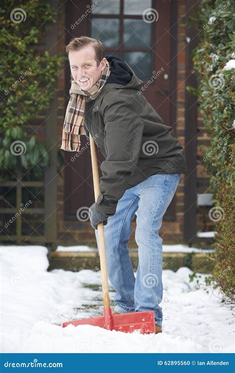 Man Clearing Snow Covered Path Outside Home Stock Photo Image Of