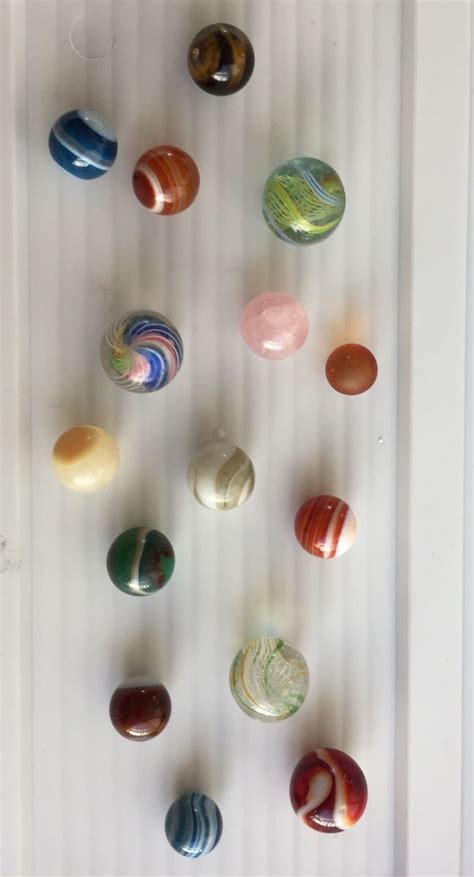 An Assortment Of Marbles Hanging On A Wall