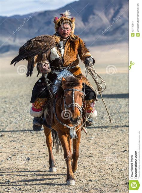Kazakh Eagle Hunters Traditional Clothing While Hunting To The Hare