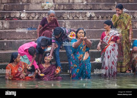 pilgrims praying and bathing in the ghats of ganges river varanasi uttar pradesh india stock