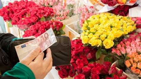 What kinds of flowers are there in stock? A woman buying flowers | Stock Photo | Colourbox