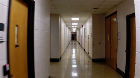 Point Of View Clip Of Walking Down The Empty Hallway Of A Modern
