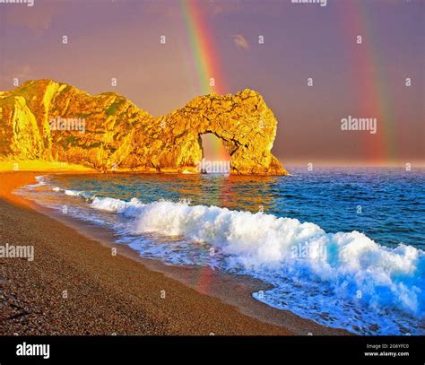 Uk Dorset Durdle Dor With Rainbow And Storm Sky Stock Photo Alamy