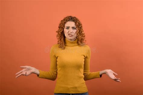 Young And Attractive Redhead Caucasian Girl In Orange Jumper Spreading