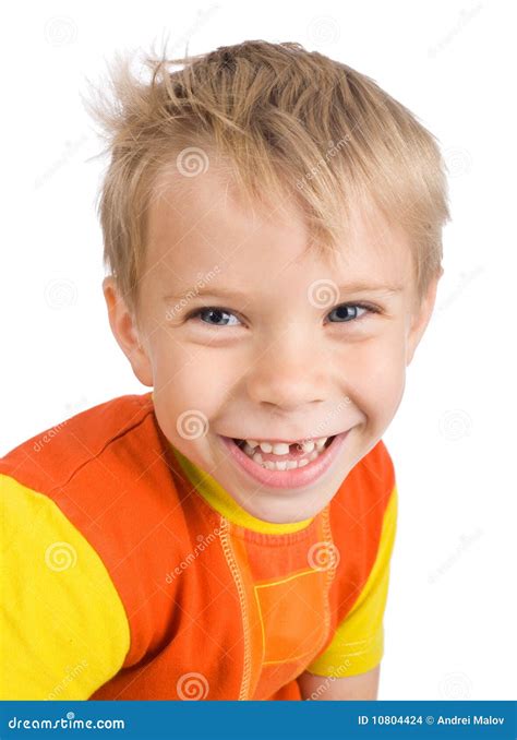 Smiling Five Year Old Caucasian Boy Standing Near A Wooden Hut In The