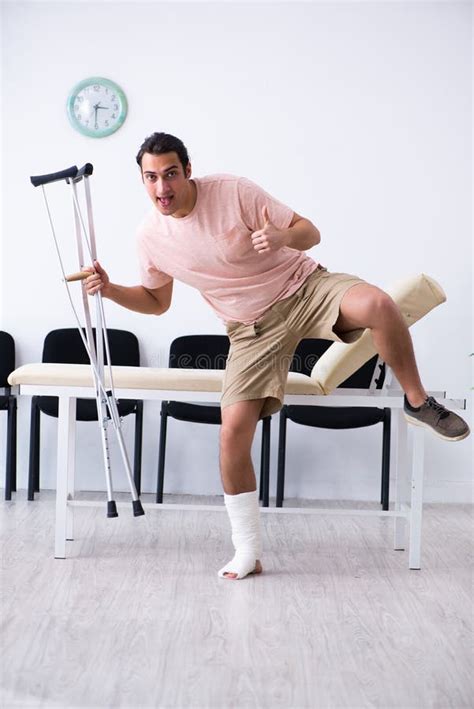 Young Injured Man Waiting For His Turn In Hospital Hall Stock Photo