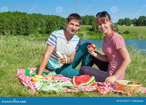 Outdoor Portrait Of Happy Loving Couple Having A Picnic At The Lake