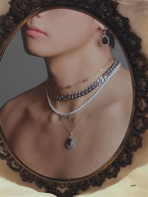 A Woman S Reflection In A Mirror With Necklaces On Her Neck And Other Jewelry