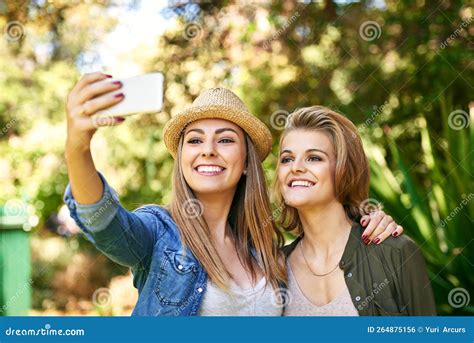Come In For One More Two Attractive Young Women Taking Selfies Outside