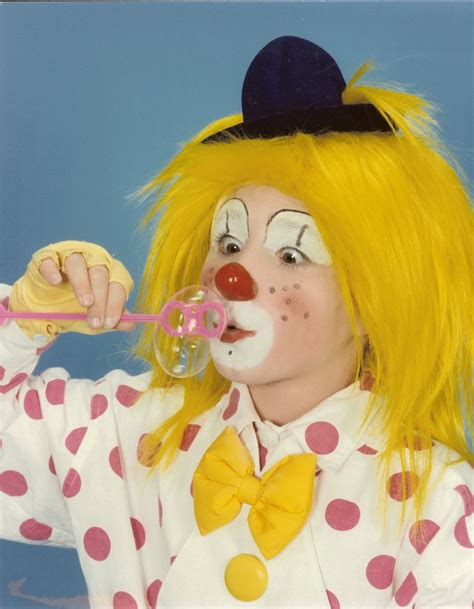 The Clown Is Blowing Bubbles With Her Nose