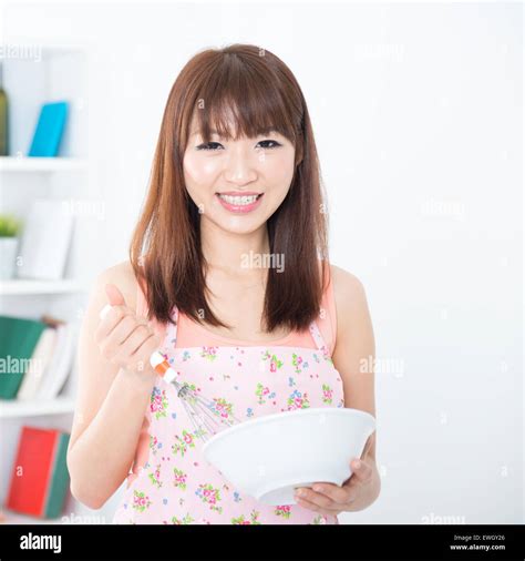 Happy Asian Housewife With Apron Preparing Food Using Manual Egg Mixer