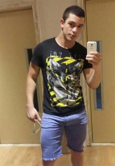 A Young Man Taking A Selfie In Front Of A Mirror With His Cell Phone