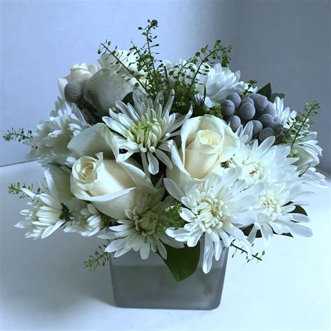 elegant white palette of flowers floral centrepieces rose arrangements floral bouquets