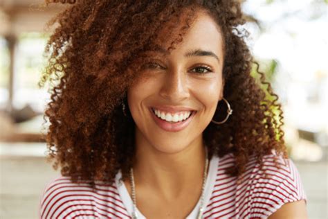 Smiling Young Woman With Curly Hair Ian Smith Dmd