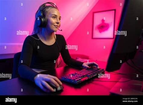 Happy Pretty Blonde Gamer Girl Playing Online Video Game On Her