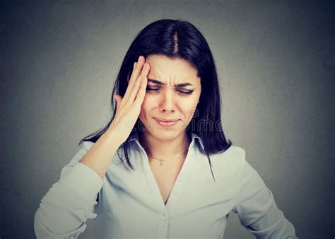 Young Woman Suffering From Headache Touching Her Head With Hand Stock