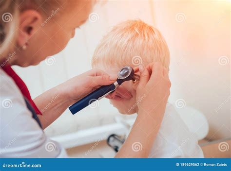 Doctor Examines Ear With Otoscope In A Pediatrician Room Stock Photo