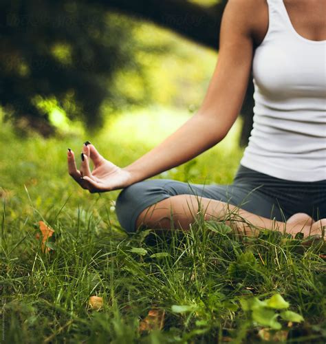 Young Woman Meditating In The Park Del Colaborador De Stocksy Jovana