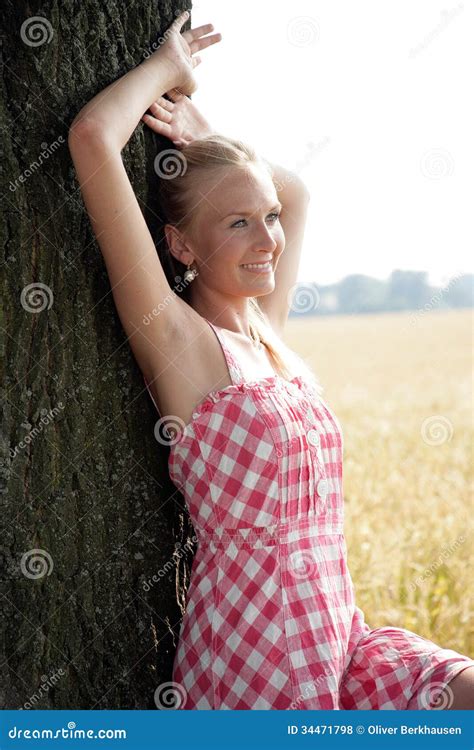 Young Woman Leaning On A Tree Royalty Free Stock Image 34471798
