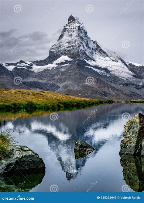 The Snowy Peak Of The Matterhorn In Switzerland Is Reflected In The