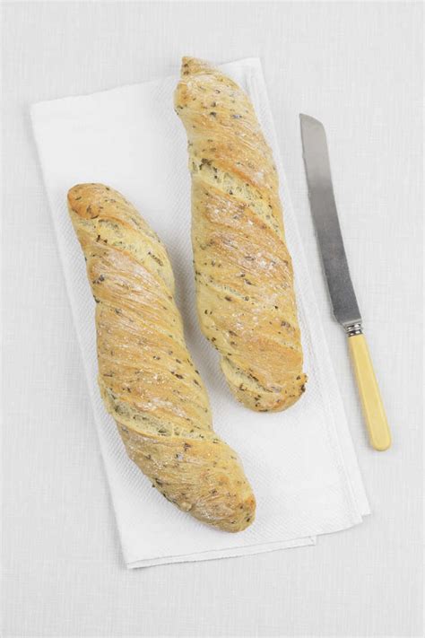 Two Homemade Ramson Baguettes And A Bread Knife Stock Photo