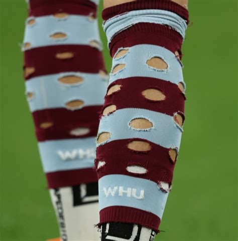 why do footballers cut holes in their socks sportsgoal
