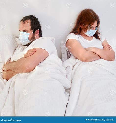 A Man And A Woman In Medical Masks Are Angry At Each Other The Husband