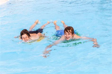 Two Friends Swimming In The Pool Stock Image Image Of Male Playing