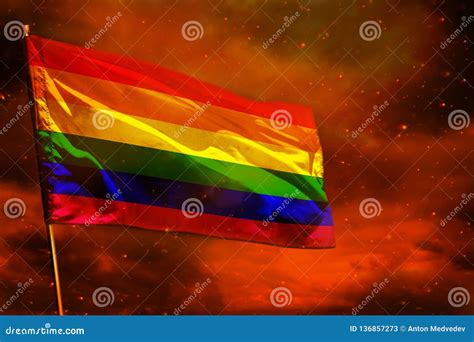 Fluttering Gay Pride Flag On Crimson Red Sky With Smoke Pillars Background Troubles Concept