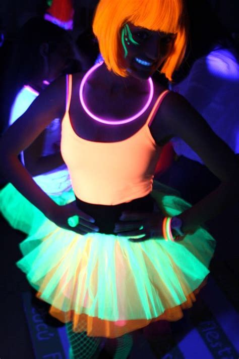 A Woman With Neon Lights On Her Body Wearing A Skirt And Glow Makeup In