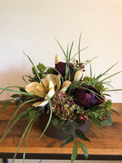 An Arrangement Of Flowers On A Wooden Table