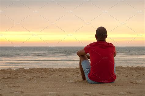 Young Man Sitting In The Beach Sand ~ People Photos ~ Creative Market