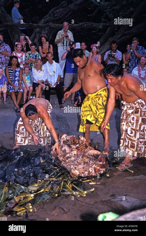 Three Hawaiian Men Dressed In Lavalavas Traditional Garments Pull A