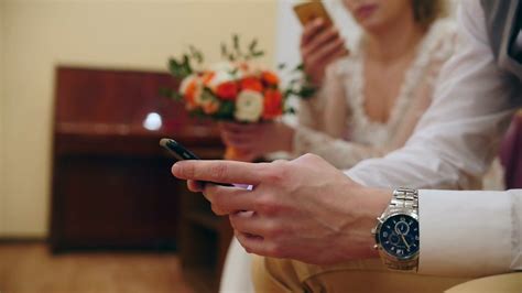 Bride And Groom On Wedding Use Smartphones After Wedding Registration