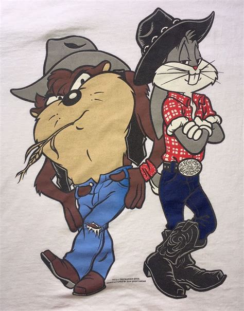 two cartoon characters are standing next to each other on a white t shirt with blue jeans and