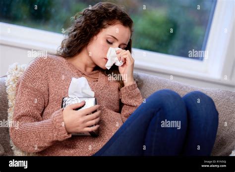 Woman With Tissues Blowing Her Nose Stock Photo Alamy