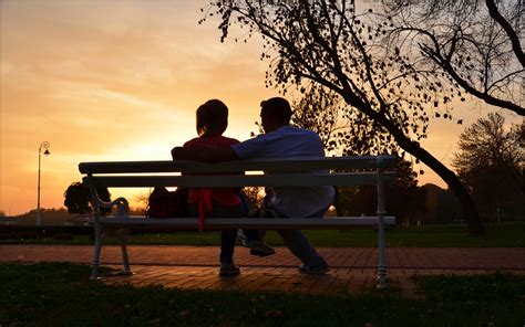 park bench couple love sunset