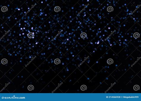 Bright And Dark Blue Little Stars Blur Bokeh On Black Background