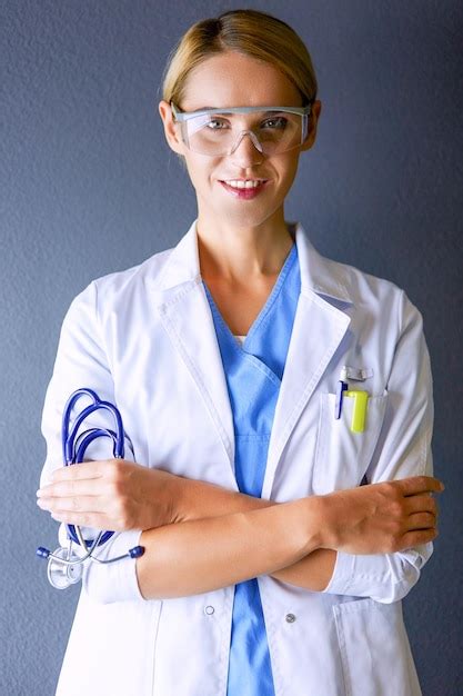 Premium Photo Portrait Of Young Woman Doctor With White Coat Standing