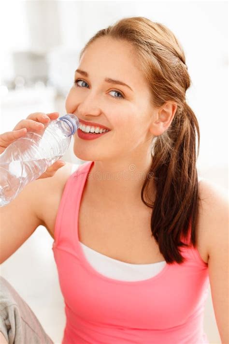 Portrait Of Attractive Young Woman Drinking Water At Gym Stock Image