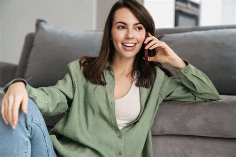 Cheerful Beautiful Woman Talking On Mobile Phone While Sitting On Floor Stock Image Image Of