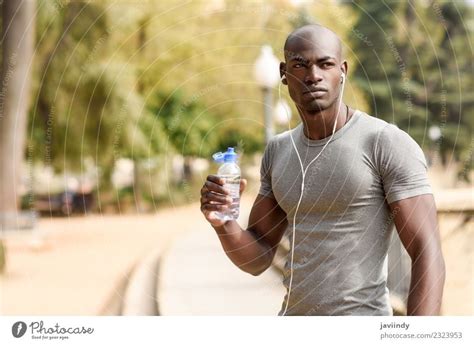 Fit Shirtless Young Black Man Drinking Water After Running A Royalty